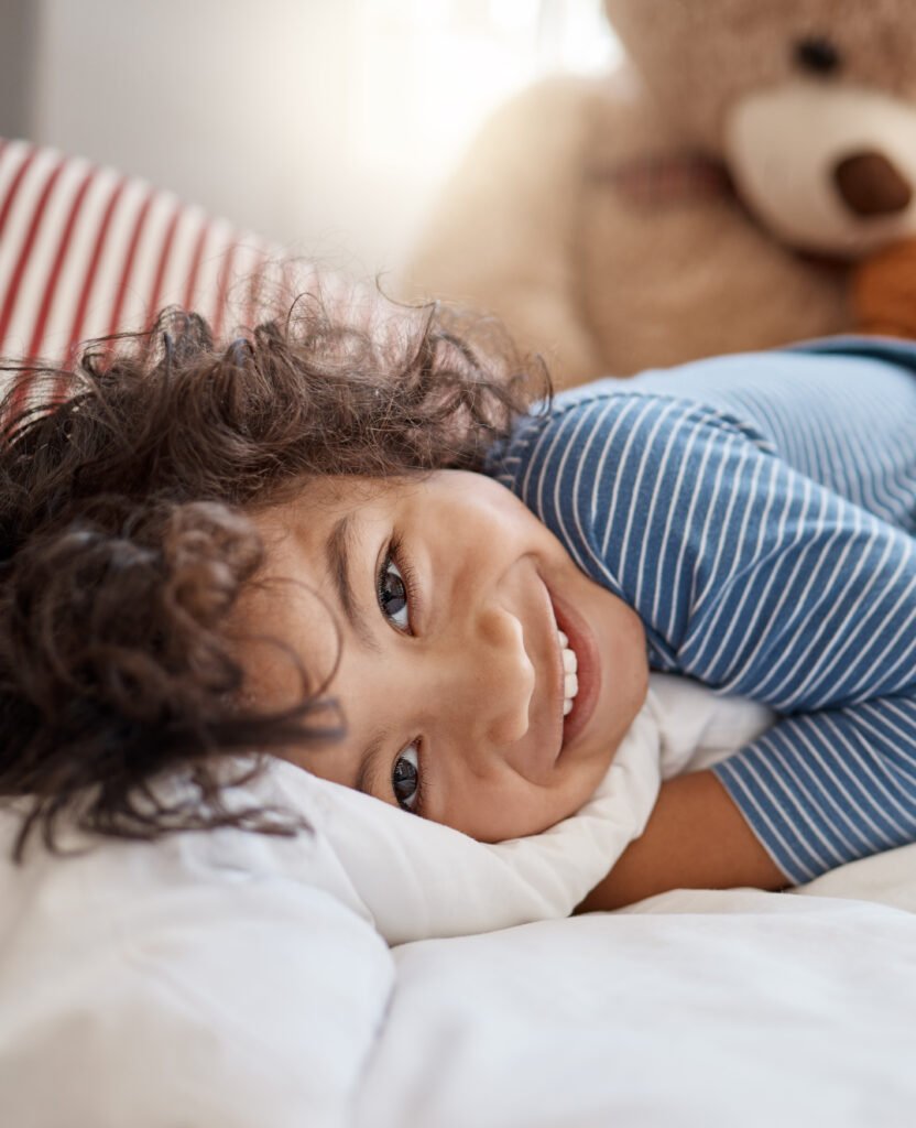 See the world the way he does. Portrait of an adorable young boy relaxing on his bed at home